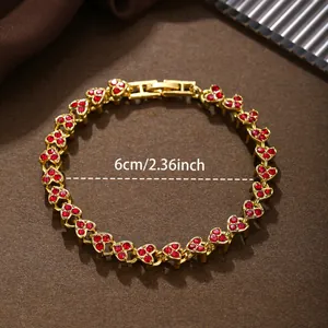 Detail view of gold heart link bracelet with red crystals and 6cm diameter label