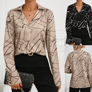 Detailed view of elegant women's V-neck blouse with abstract geometric line print
