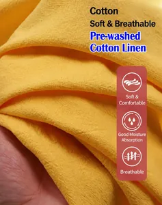 Close-up detail of breathable yellow washed cotton linen fabric showing soft texture