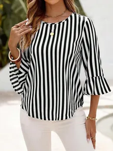 Detail view of a black and white striped top featuring elegant bell three-quarter sleeves