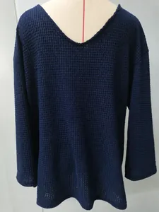 Close-up of retro navy blue men's V-neck knit sweater with hollow-out mesh texture