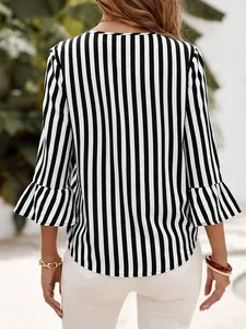 Back view of a stylish black and white vertical striped blouse with bell ruffle sleeves