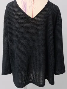 Detailed view of black V-neck knit sweater with vintage hollow waffle texture design