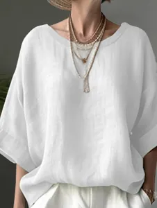Detailed view of white linen-textured blouse with round neck and drop shoulder