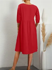 Back view of red cotton linen loose pleated dress with lantern sleeves