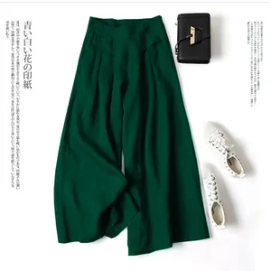 Close-up of elegant dark green cotton linen wide leg pants with loose fit and high waist
