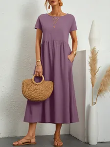 Close-up of a purple short-sleeved maxi dress with crinkled texture and elastic waist