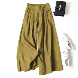 Flat lay view of mustard yellow cotton-linen wide-leg pants with styling accessories