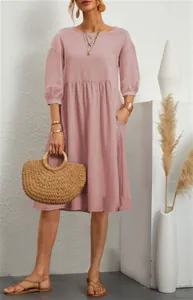 Detailed view of a mauve cotton linen midi dress featuring lantern sleeves and side pockets.