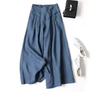 Styled flat lay of blue cotton-linen wide-leg cropped pants with high waist detail.