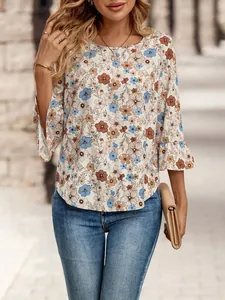 Detailed view of floral print blouse with 3/4 bell sleeves and round neckline
