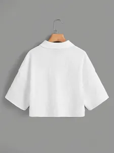 Back view of a white cropped textured shirt with short sleeves and collar detail