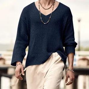 Close-up detail of men's navy V-neck hollow-out knit sweater for a relaxed beach style