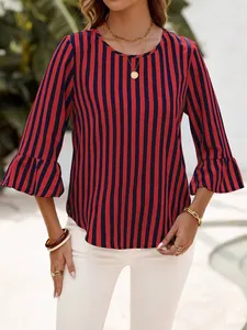 Outdoor lifestyle view of red and navy vertical striped 3/4 bell sleeve blouse