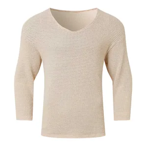Close-up of men's V-neck long sleeve top with cream waffle knit texture and soft fabric