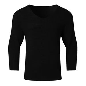 Detailed view of the waffle knit texture on a black men's V-neck long sleeve sweater