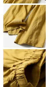Detail view of mustard yellow cotton linen wide-leg pants texture and elastic waistband