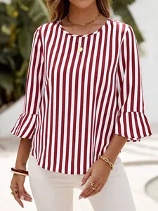 Front view of a woman wearing a red and white striped top with flare sleeves in sunlight