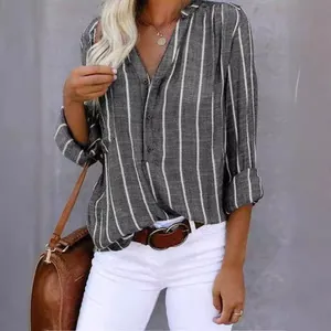 Detail of a grey and white vertical striped shirt with button-down V-neck and rolled sleeves.