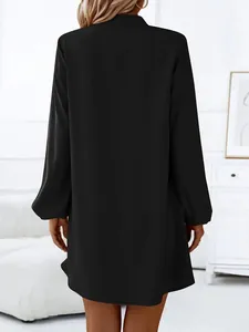 High quality back view detail of a classic black long-sleeved A-line dress for women