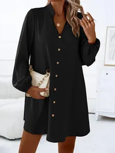 Close-up detail of a solid black V-neck long sleeve A-line dress featuring front buttons