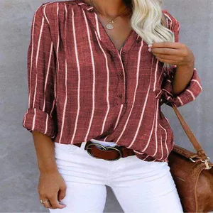 Detailed shot of women's burgundy vertical striped V-neck blouse with stylish rolled sleeves