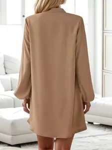 Back view of a minimalist khaki long sleeve A-line shirt dress with turn-down collar.