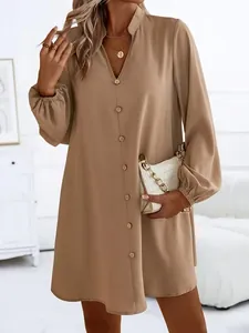 Detailed view of women's solid camel color V-neck long sleeve dress with front button closure