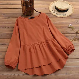 Casual orange lantern sleeve linen-style blouse featuring a ruffled peplum hem design