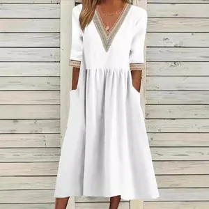 Elegant white loose cotton linen midi dress featuring a lace V-neck and half sleeves for summer