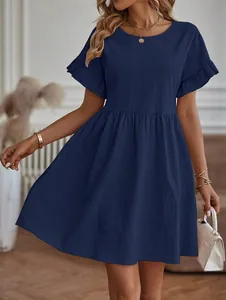 Close-up of navy blue cotton-linen dress featuring ruffled sleeves and a round neckline