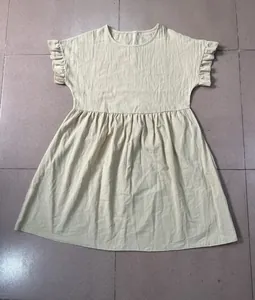 Soft pale yellow cotton linen dress featuring a round neck and feminine ruffle short sleeves