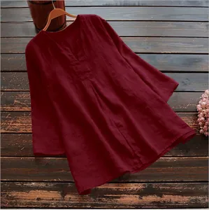 Detailed view of a loose burgundy cotton linen blouse featuring 3/4 sleeves and a V-neckline.