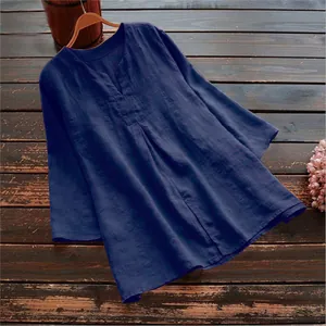 Detail view of navy blue cotton linen three-quarter sleeve top on rustic wood