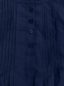 Close-up of navy blue slub cotton linen shirt with button placket and pintuck pleats.