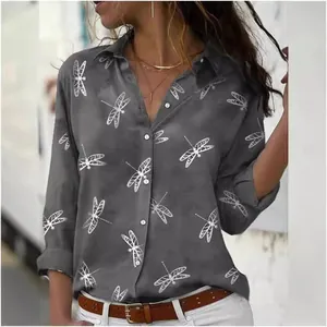Close-up of grey long-sleeved shirt featuring white dragonfly print and lapel collar