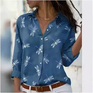 Detail of blue long-sleeved shirt featuring white dragonfly prints and buttons
