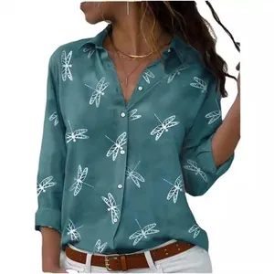 Detail of women's green long-sleeved shirt with white dragonfly print and lapel collar.