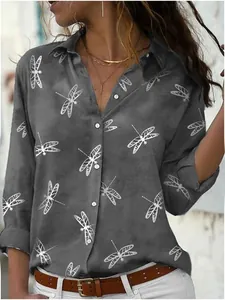 Close-up of women's casual grey shirt featuring a silver dragonfly print and button details