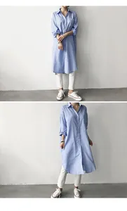 Detailed view of a stylish women's blue and white striped loose long-sleeve tunic shirt