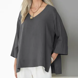 Detail view of a loose grey V-neck cotton linen blouse with three-quarter sleeves
