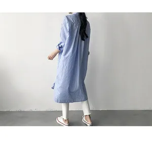 Back view of a long blue and white vertical striped loose fit shirt for women.