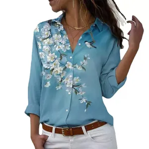 Detail shot of women's blue lapel shirt with elegant white floral and bird print.