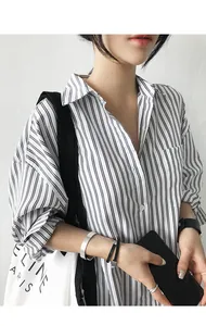Detail view of a loose blue and white vertical striped long-sleeved shirt for women.