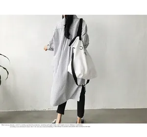 Back view of a model in a loose blue and white striped long-sleeved shirt jacket