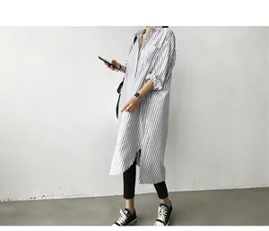 Close-up of a blue and white vertical striped long-sleeved shirt on model