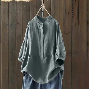 Detailed view of grey stand collar linen blouse with buttons and natural texture