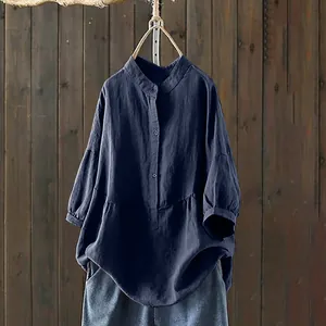 Close-up of navy blue loose-fit long sleeve shirt with stand collar and buttons