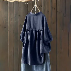 Loose navy blue cotton blouse with stand collar and elegant pleated back details.