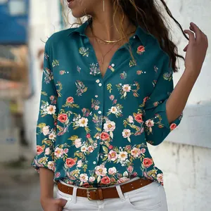 Close-up detail of the elegant floral print and single-breasted buttons on teal shirt